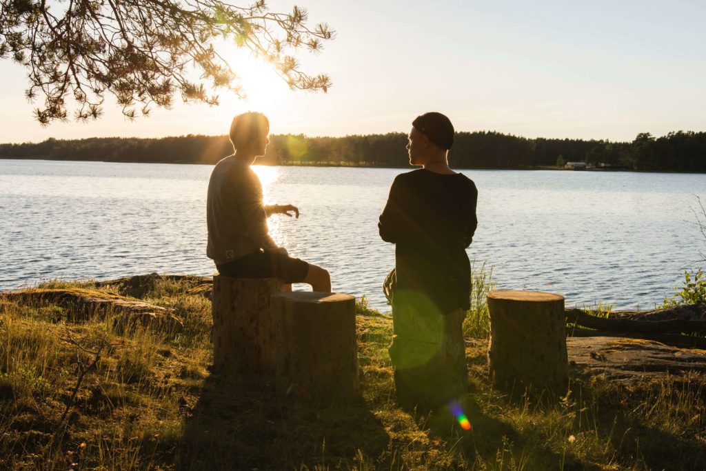 To drenge snakker ved en sø