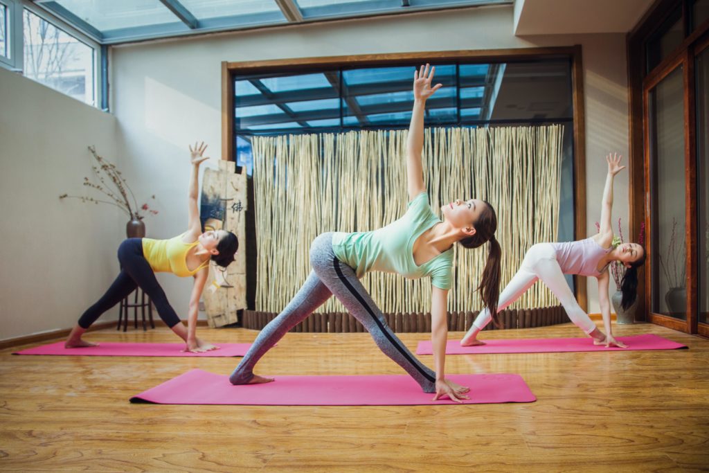 Tre kvinder dyrker yoga